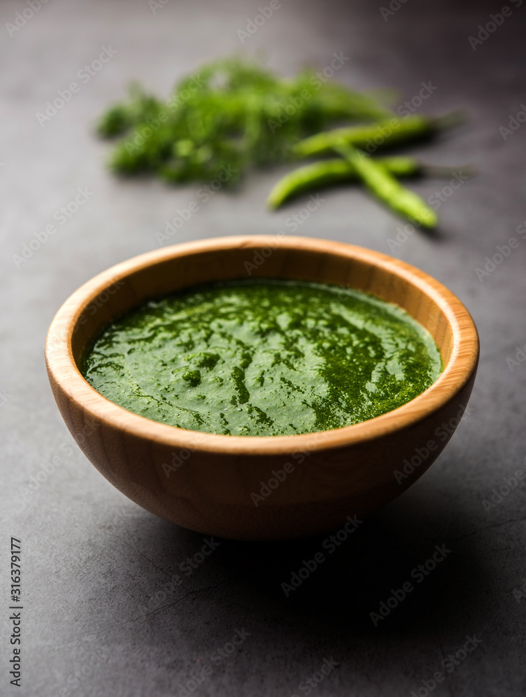 Kothimbir or Dhaniya Chutney made using Cilantro or coriander with chilli, served in a bowl. selective focus Kothimbir or Dhaniya Chutney made using Cilantro or coriander with chilli, served in a bowl. selective focus