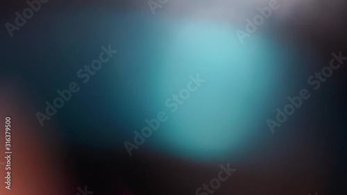 Abstract slow motion of light lens flare effect with light pulses or light leak on black background. Motion for creative transition, adding background on videos.