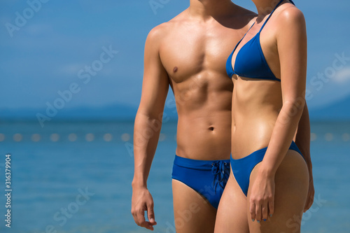 Young sports couple on Tropical Beach. Fashion Photo Shoot.