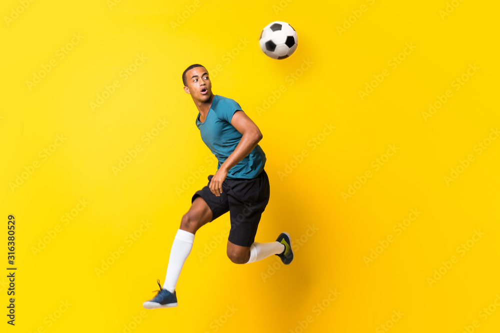 Afro American football player man over isolated yellow background