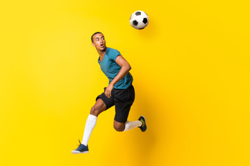 Afro American football player man over isolated yellow background