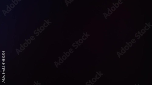 Abstract slow motion of light lens flare effect with light pulses or light leak on black background. Motion for creative transition, adding background on videos.