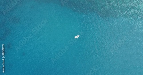 Aerial view of white Boat in the Sea. Flying above Boat. Alone boat in the Ocean 