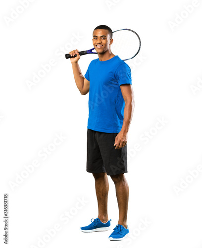 Full-length shot of African American tennis player man over isolated white background © luismolinero