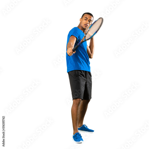 Full-length shot of African American tennis player man over isolated white background © luismolinero