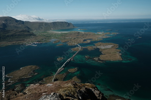 Hike to Volandstinden mountain where is a great view t ofredvang bridge. famous tourist spot near to reine. photo