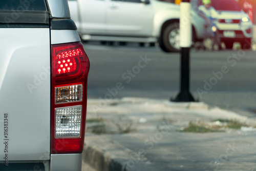 Pick up car stop on the road. Open brake light. Prepare for u-turn. photo