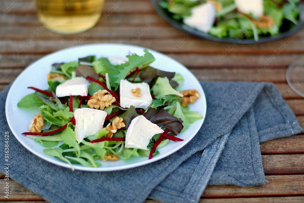 Fresh salad with lettuce, beetroot, walnut and camembert cheese