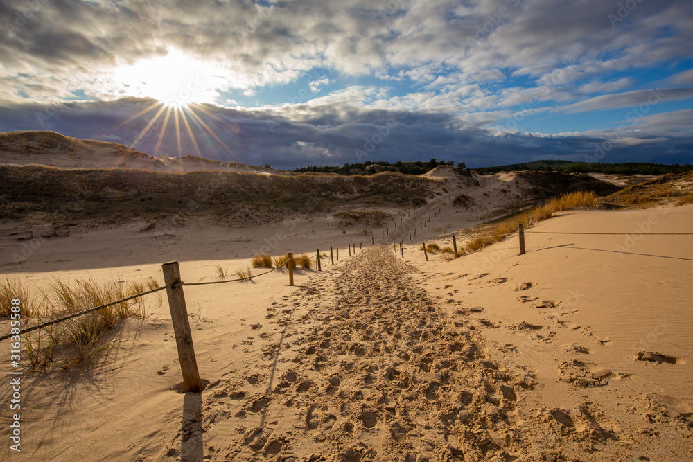 Dunes in the Slowinski National Park. Landscape with beautiful sky, clouds and dunes in the sun. Czolpino, Leba, Poland.