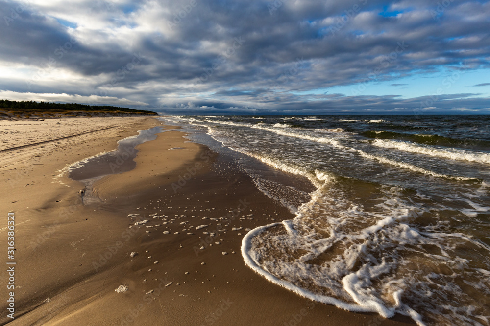 A beach after a storm during a windy evening in the Slowinski National Park. Czolpino, Leba, Poland.