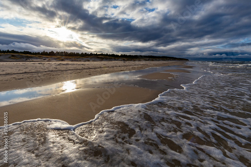 Obraz na płótnie A beach after a storm during a windy evening in the Slowinski National Park. Czolpino, Leba, Poland. w salonie