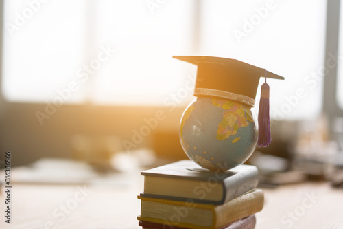 Education study abroad in Global world,Back to School and Graduation cap on student hand holding Earth globe map,Success of Global business study abroad educational,congratulation Graduation Ceremony photo
