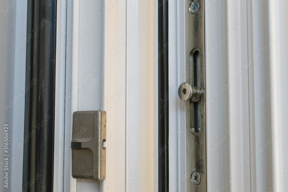 Locking point on a tilt and turn aluminum casement window with European groove mechanism Locking point on a tilt and turn aluminum casement window with European groove mechanism