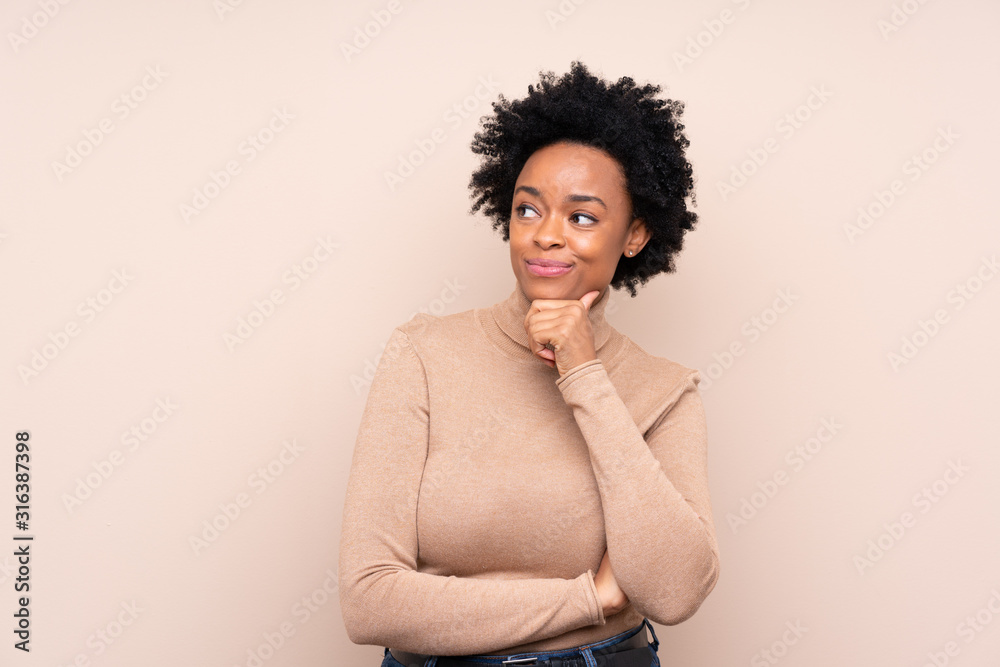African american woman over isolated background looking to the side African american woman over isolated background looking to the side