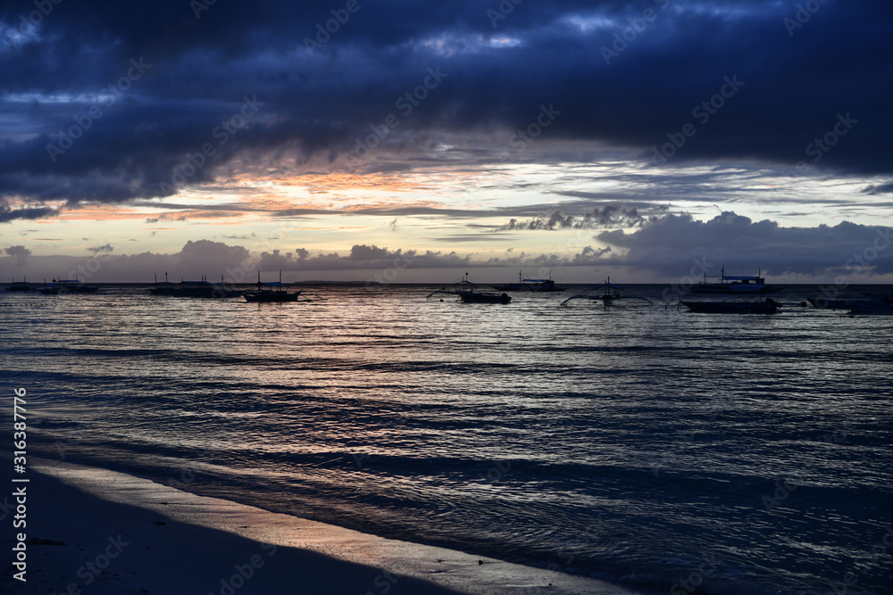 Fototapeta premium sunrise on a tropical island with a white sandy beach in the philippines
