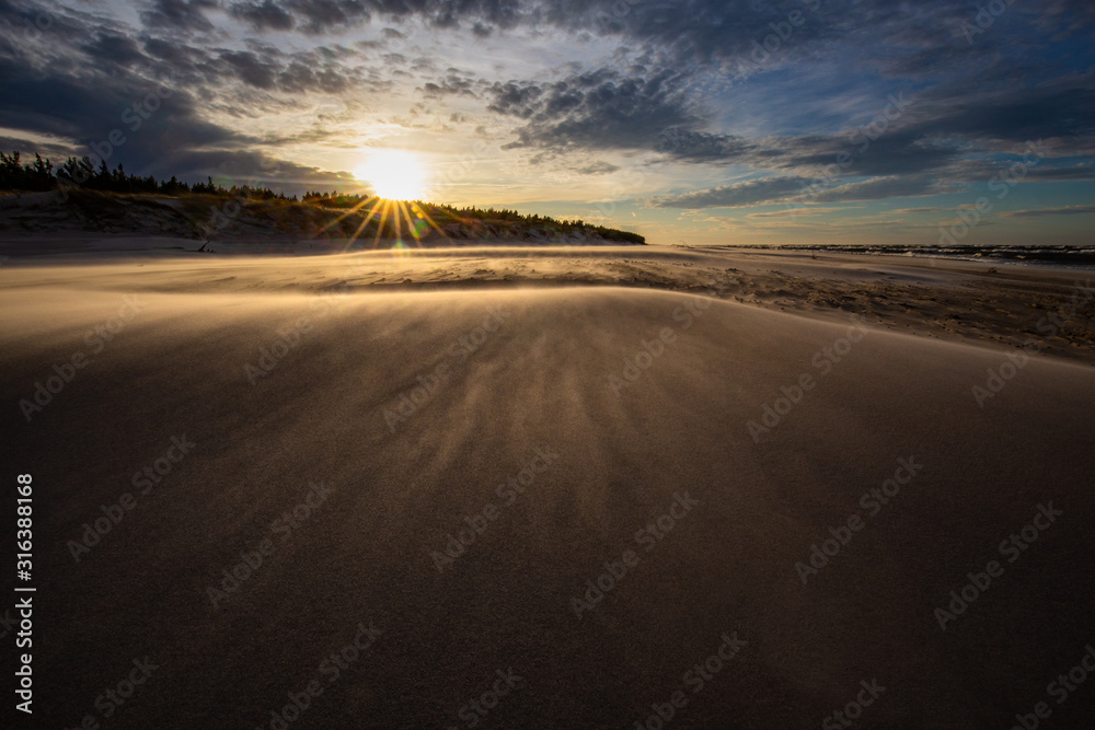 A beach after a storm during a windy evening in the Slowinski National Park. Czolpino, Leba, Poland.