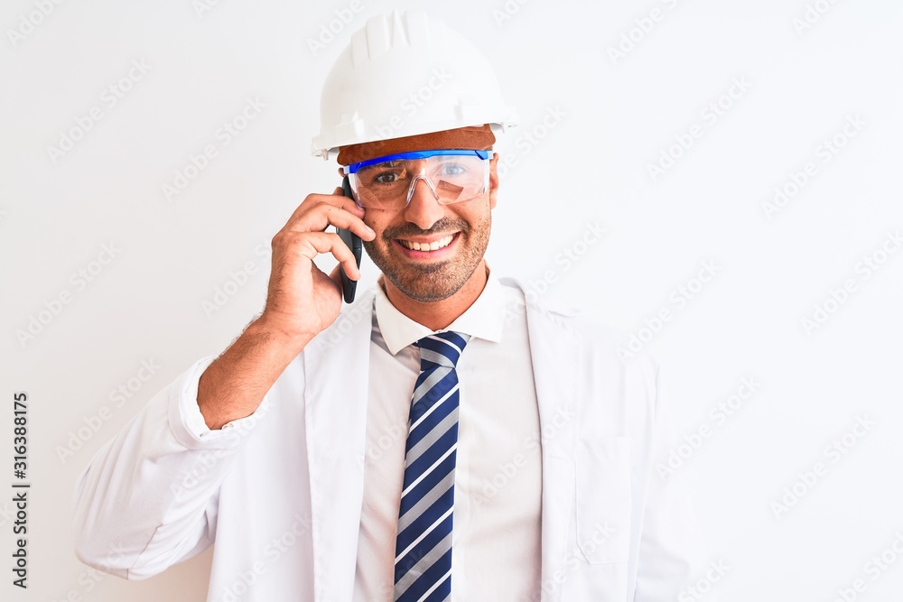 Young scientist man wearing safety helmet and calling using smartphone over isolated background with a happy face standing and smiling with a confident smile showing teeth
