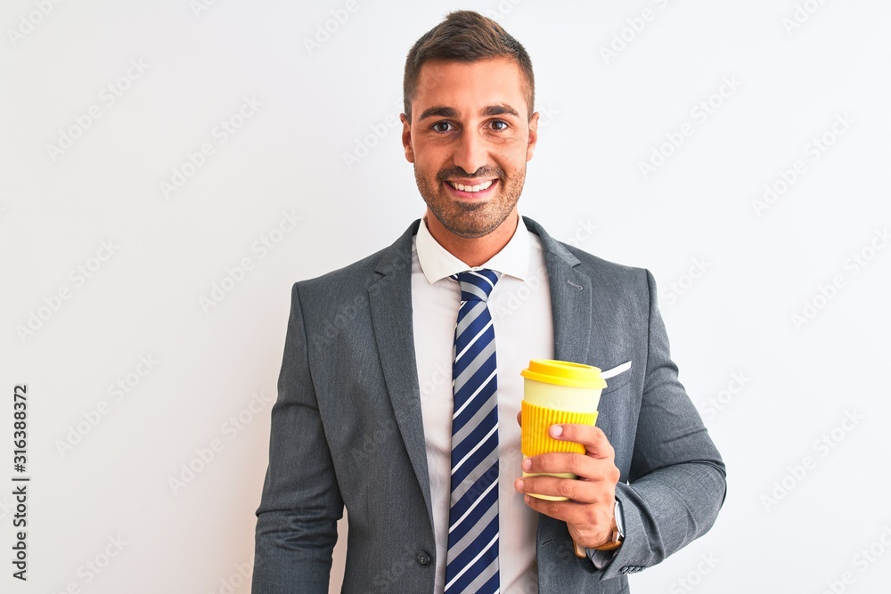 Young handsome business man drinking take away coffee over isolated background with a happy face standing and smiling with a confident smile showing teeth Young handsome business man drinking take away coffee over isolated background with a happy face standing and smiling with a confident smile showing teeth
