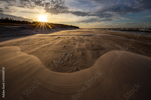 Obraz na płótnie A beach after a storm during a windy evening in the Slowinski National Park. Czolpino, Leba, Poland. w salonie