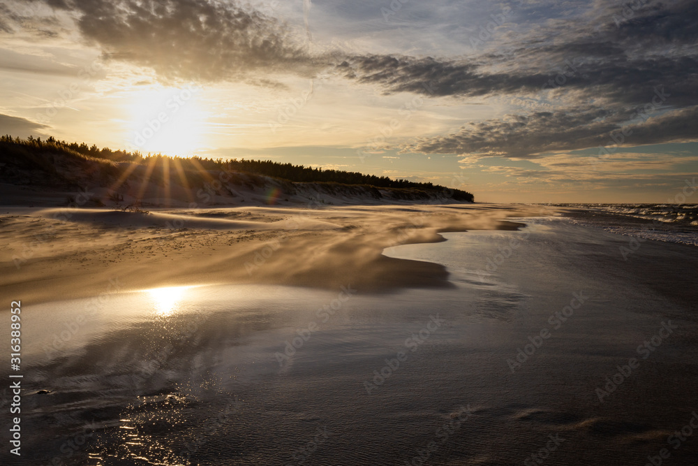 A beach after a storm during a windy evening in the Slowinski National Park. Czolpino, Leba, Poland.