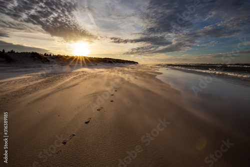 A beach after a storm during a windy evening in the Slowinski National Park. Czolpino, Leba, Poland.