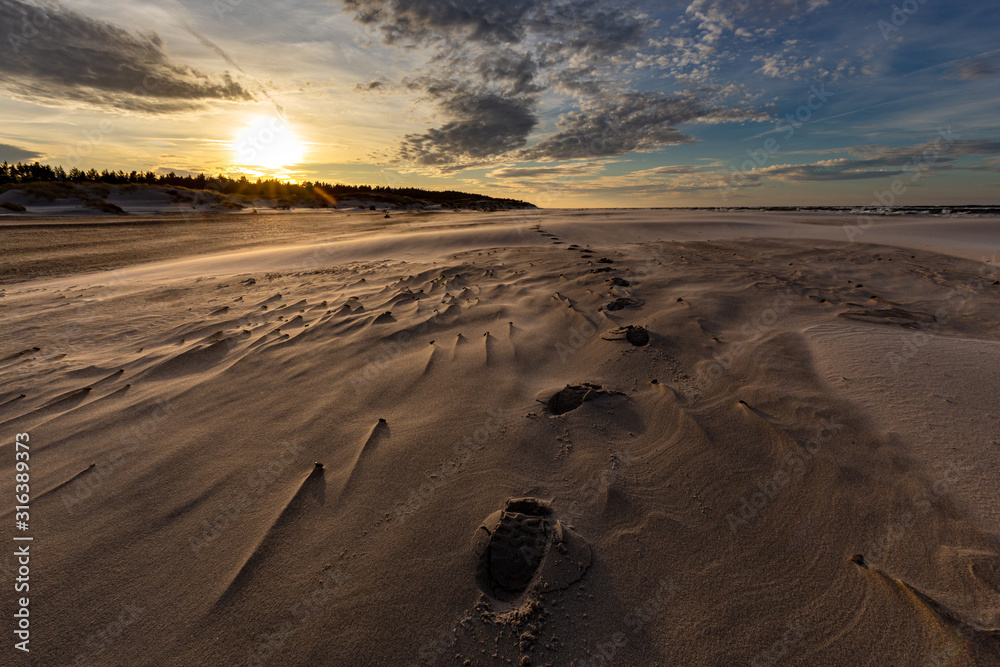 A beach after a storm during a windy evening in the Slowinski National Park. Czolpino, Leba, Poland.