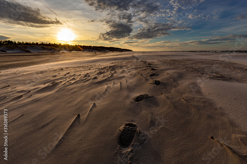 Obraz na płótnie A beach after a storm during a windy evening in the Slowinski National Park. Czolpino, Leba, Poland. w salonie