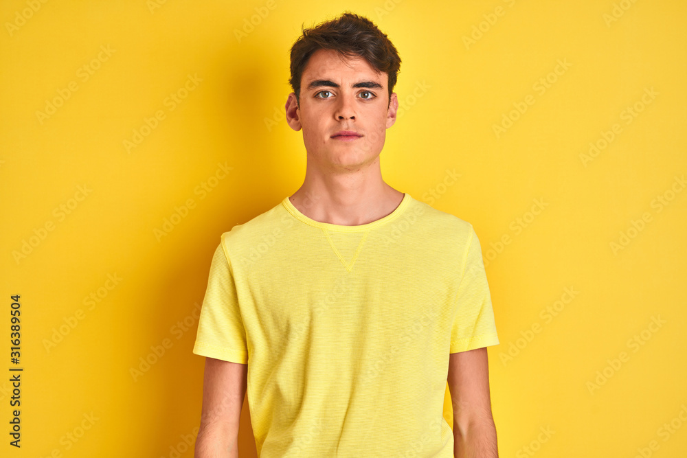 custom made wallpaper toronto digitalTeenager boy wearing yellow t-shirt over isolated background Relaxed with serious expression on face. Simple and natural looking at the camera.