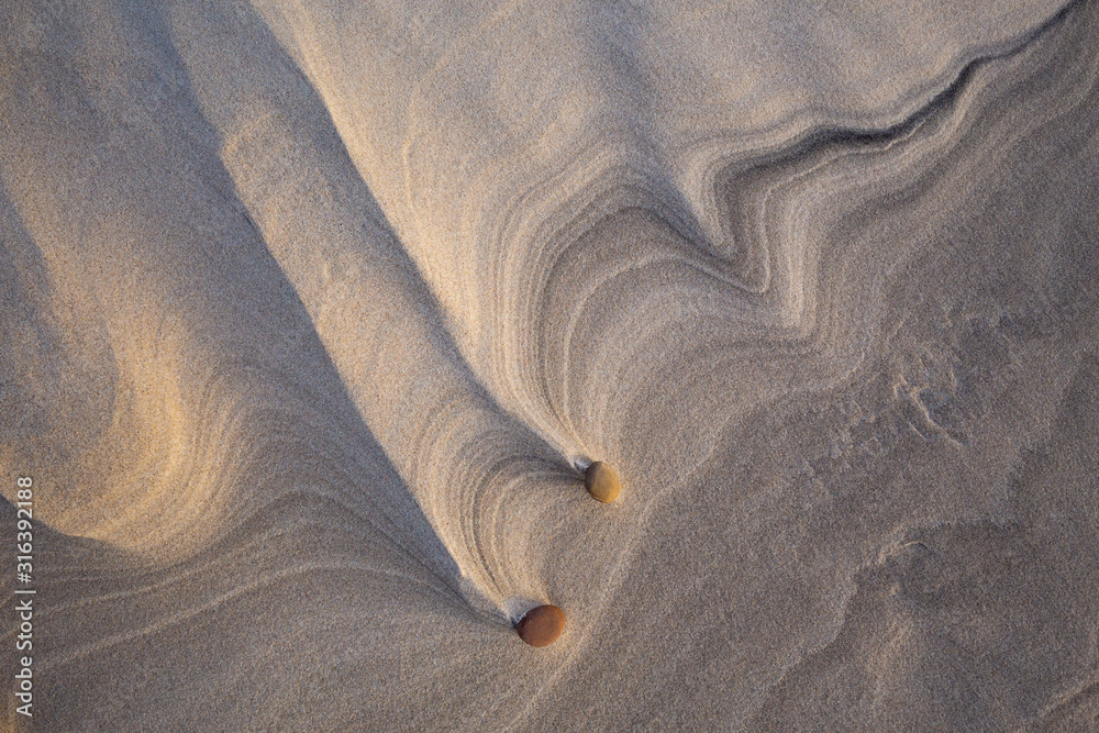 Beautiful patterns created by the wind on the beach in the Slowinski National Park. Czolpino, Leba, Poland.