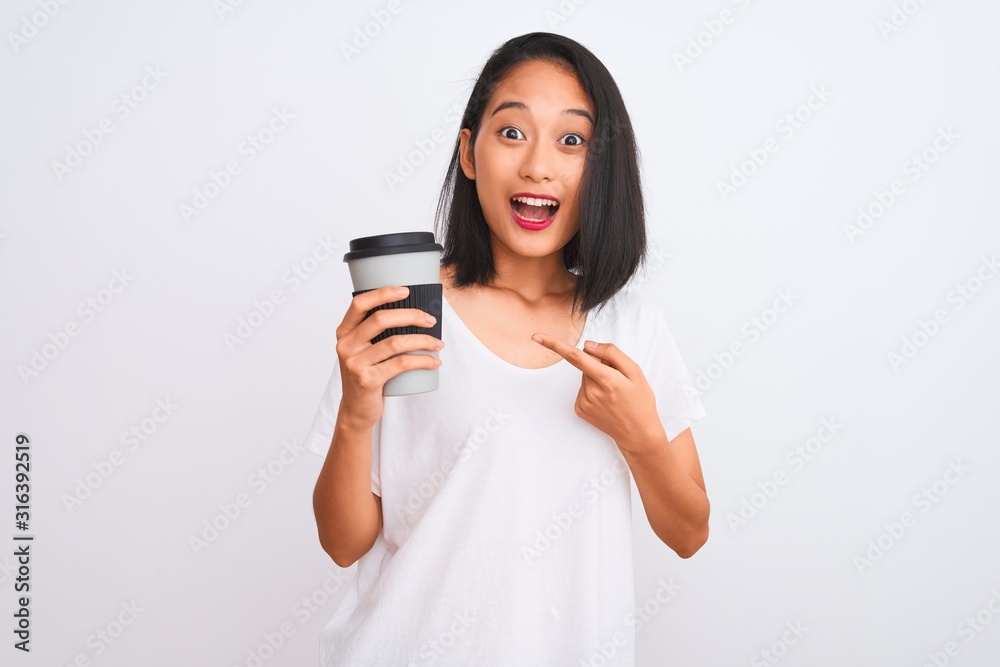 Young chinese woman drinking take away glass of coffee over isolated white background very happy pointing with hand and finger Young chinese woman drinking take away glass of coffee over isolated white background very happy pointing with hand and finger