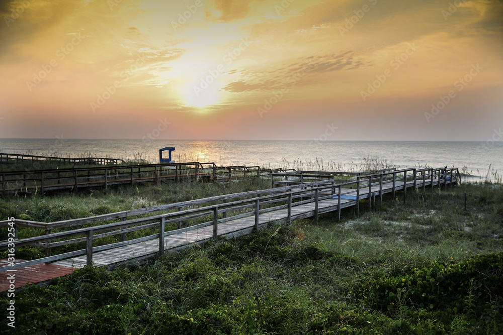 Walkway at the beach at sunset / sunrise