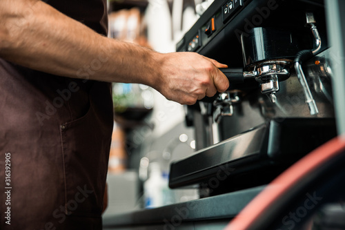 Barista preparing espresso in his coffee shop