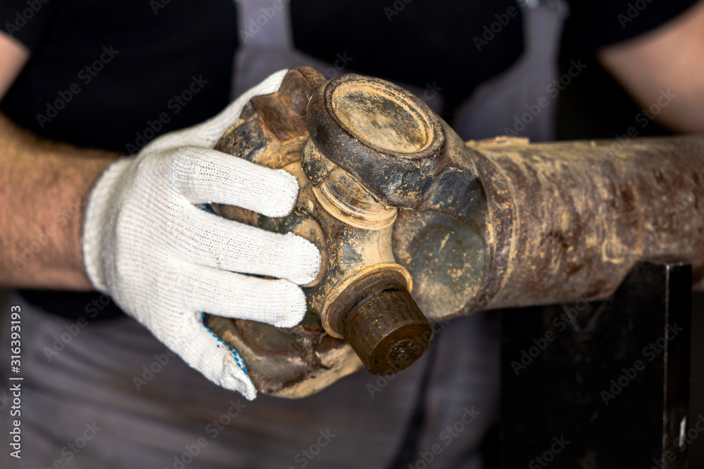 Foto de The mechanic diagnoses a malfunction of the propeller shaft of the car. do Stock Adobe