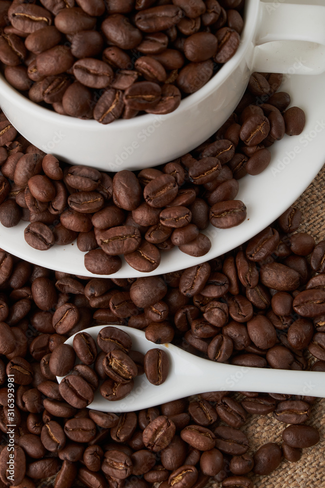 Coffee Cup and coffee beans on the table close-up Coffee Cup and coffee beans on the table close-up