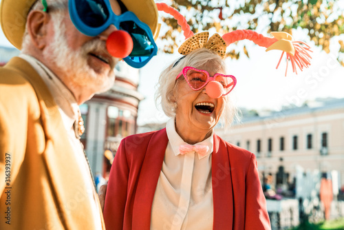 Beautiful elderly woman in a funny suit laughing photo