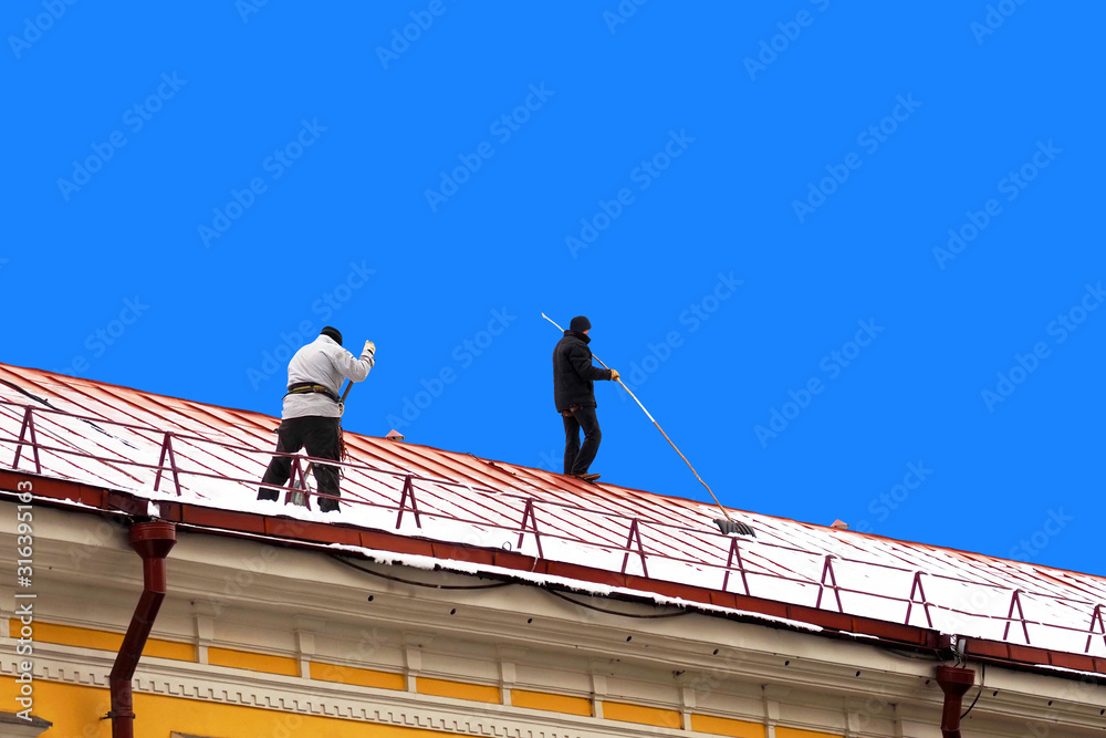 Snow removal from city roofs in winter. Roof work