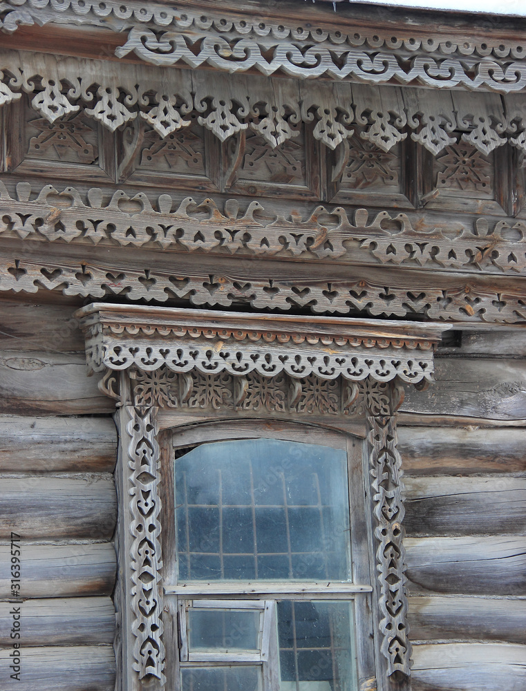 Openwork cornice and window frames on an old wooden house