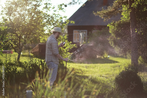 Man farmer watering a vegetable garden