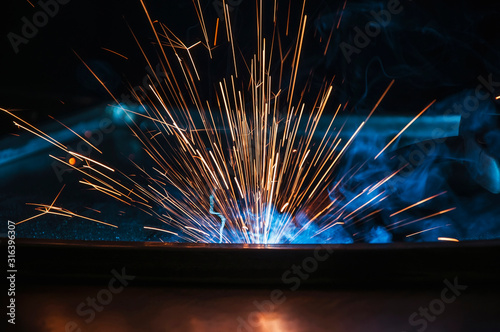 Industrial welding of iron construction. Process by manual welding. Splatter