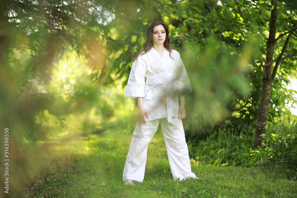 Pregnant woman doing yoga exercise in nature on a summer Pregnant woman doing yoga exercise in nature on a summer