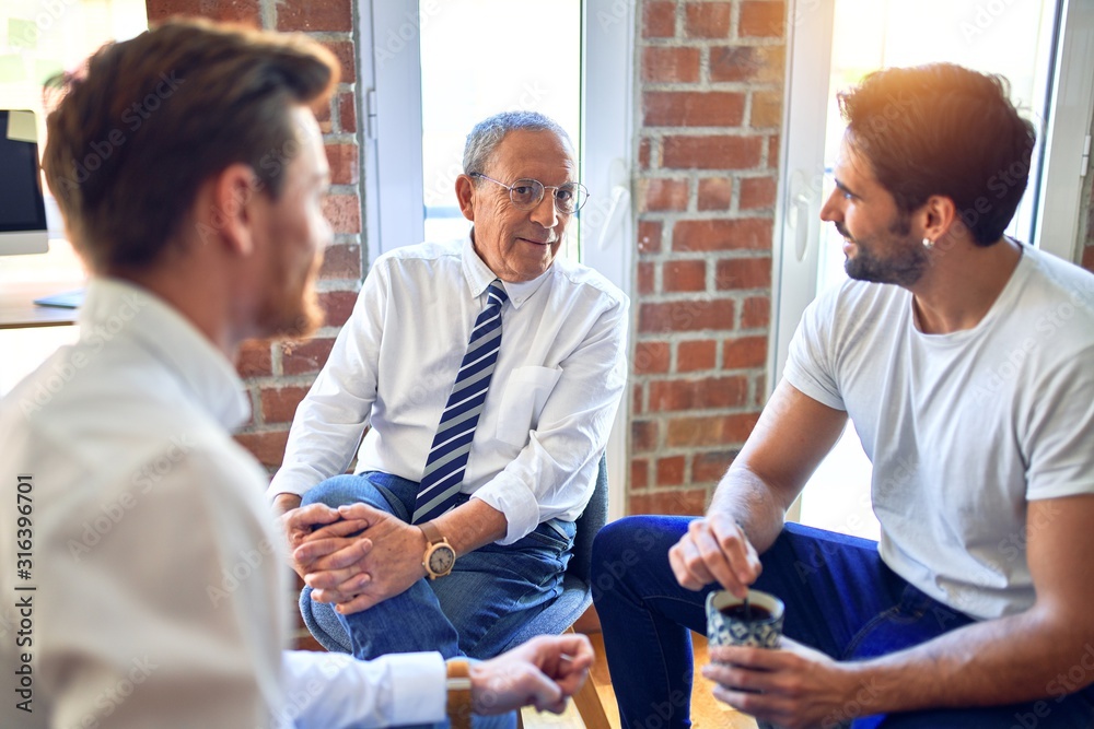 Fototapeta premium Handsome businessmen smiling happy. Sitting with smile on face speaking taking rest at the office