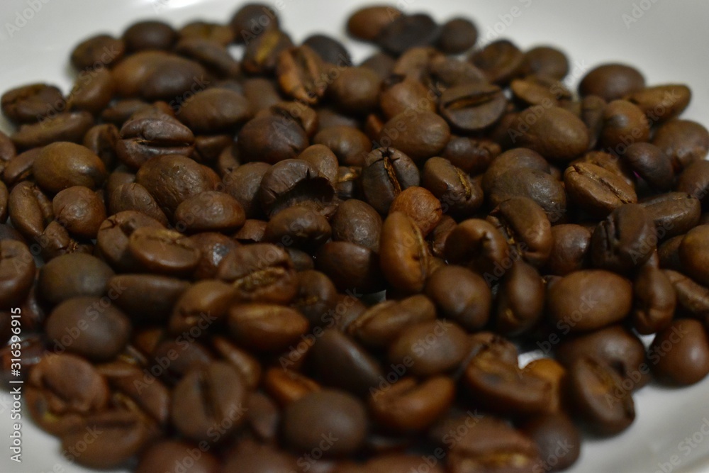 Roasted coffee beans on a substrate. Roasted coffee beans on a substrate.