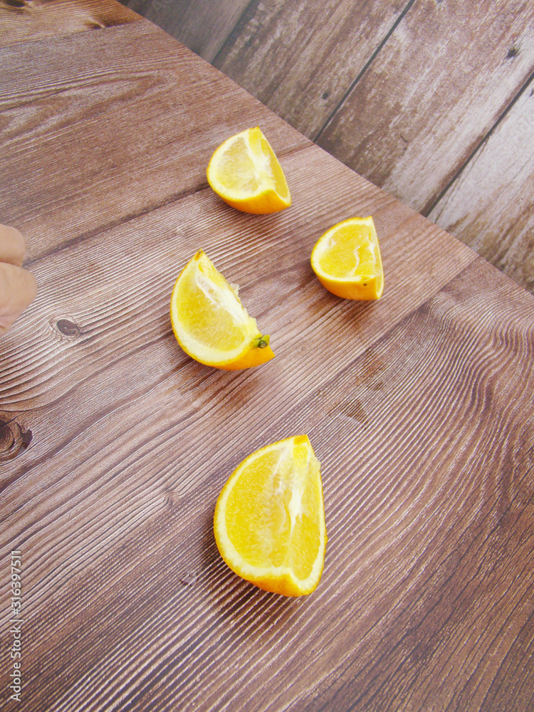 Four slices of orange on the wooden table Four slices of orange on the wooden table