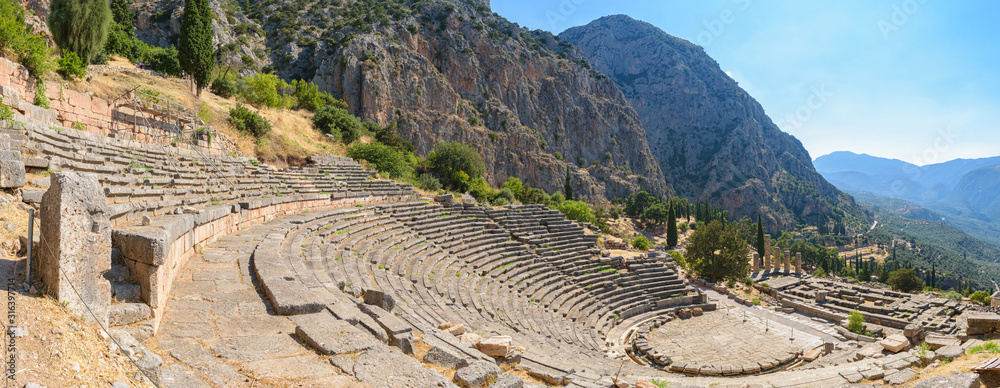 Ancient theatre of Delphi with temple of Apollo at the background, panoramic view