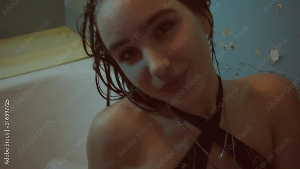 Beautiful sexy lady taking shower in her bathroom. Portrait of fashion model girl indoors. Beauty woman with attractive body in lingerie