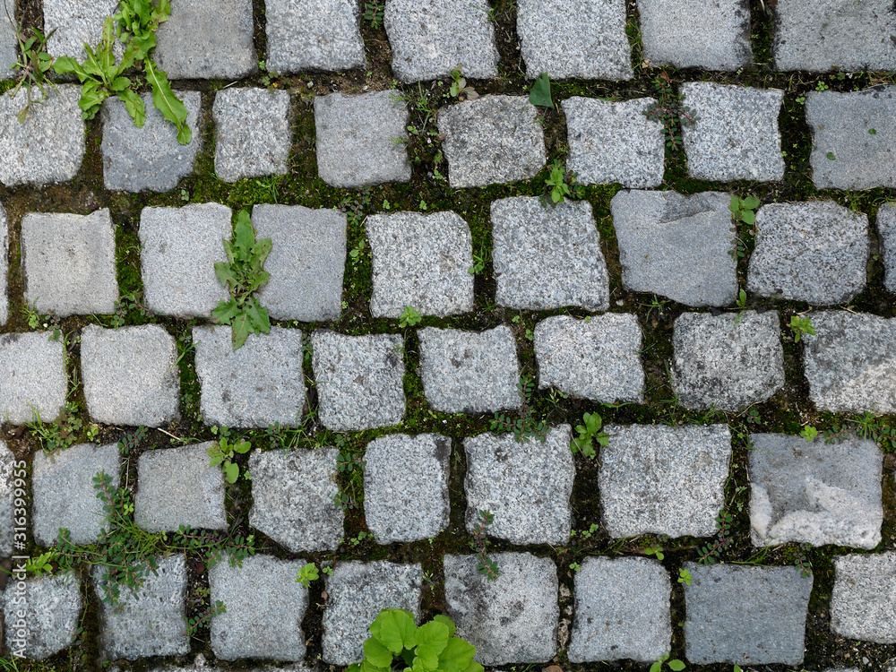 Paving stones made of granite square stones. Background from tiles. Paving stones made of granite square stones. Background from tiles.