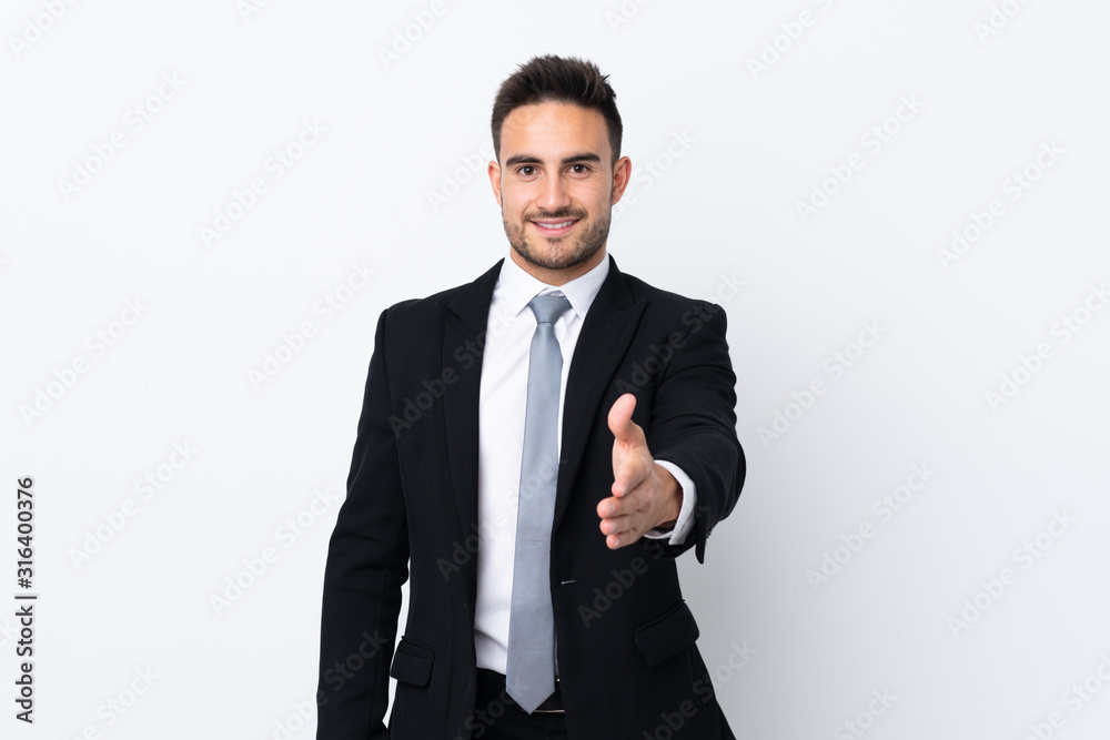 Young business man over isolated background handshaking after good deal Young business man over isolated background handshaking after good deal