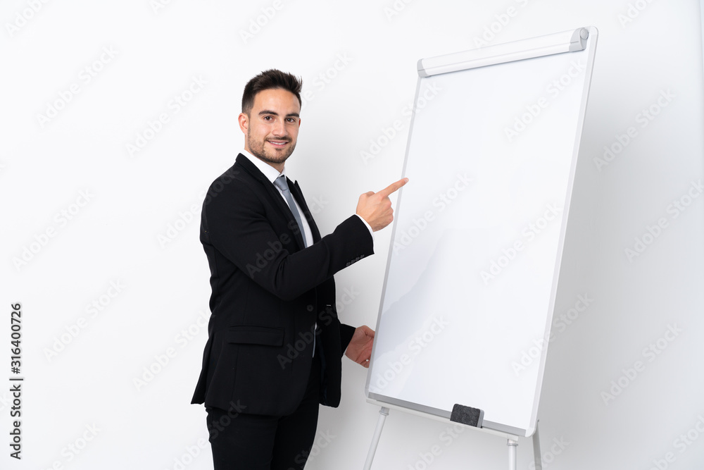 Young man giving a presentation on white board and writing in it Young man giving a presentation on white board and writing in it