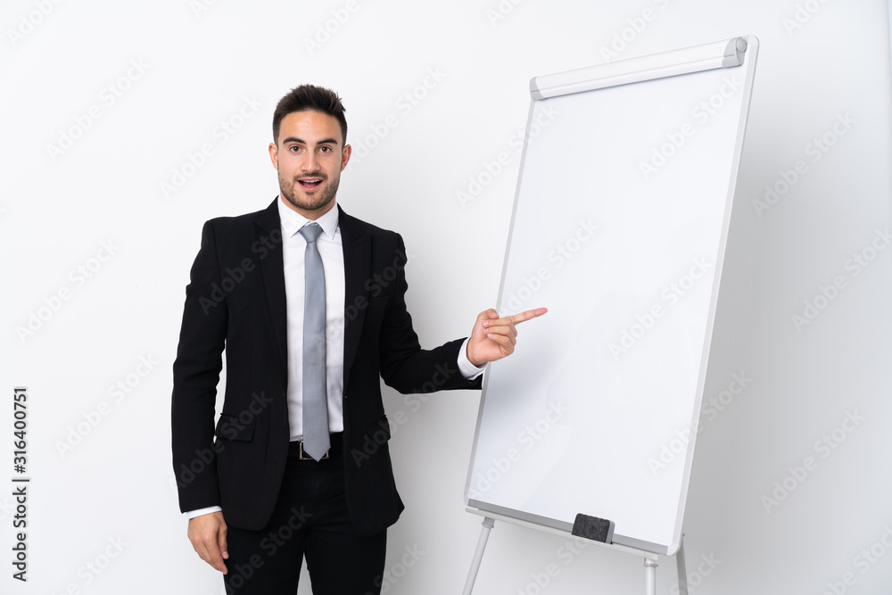 Young man giving a presentation on white board Young man giving a presentation on white board