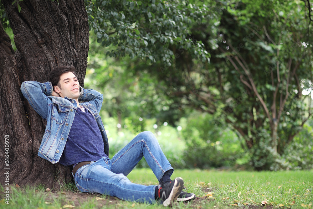 A young man walks in the park at lunch time. A man is on a walk in the city. A student in the park. A young man walks in the park at lunch time. A man is on a walk in the city. A student in the park.